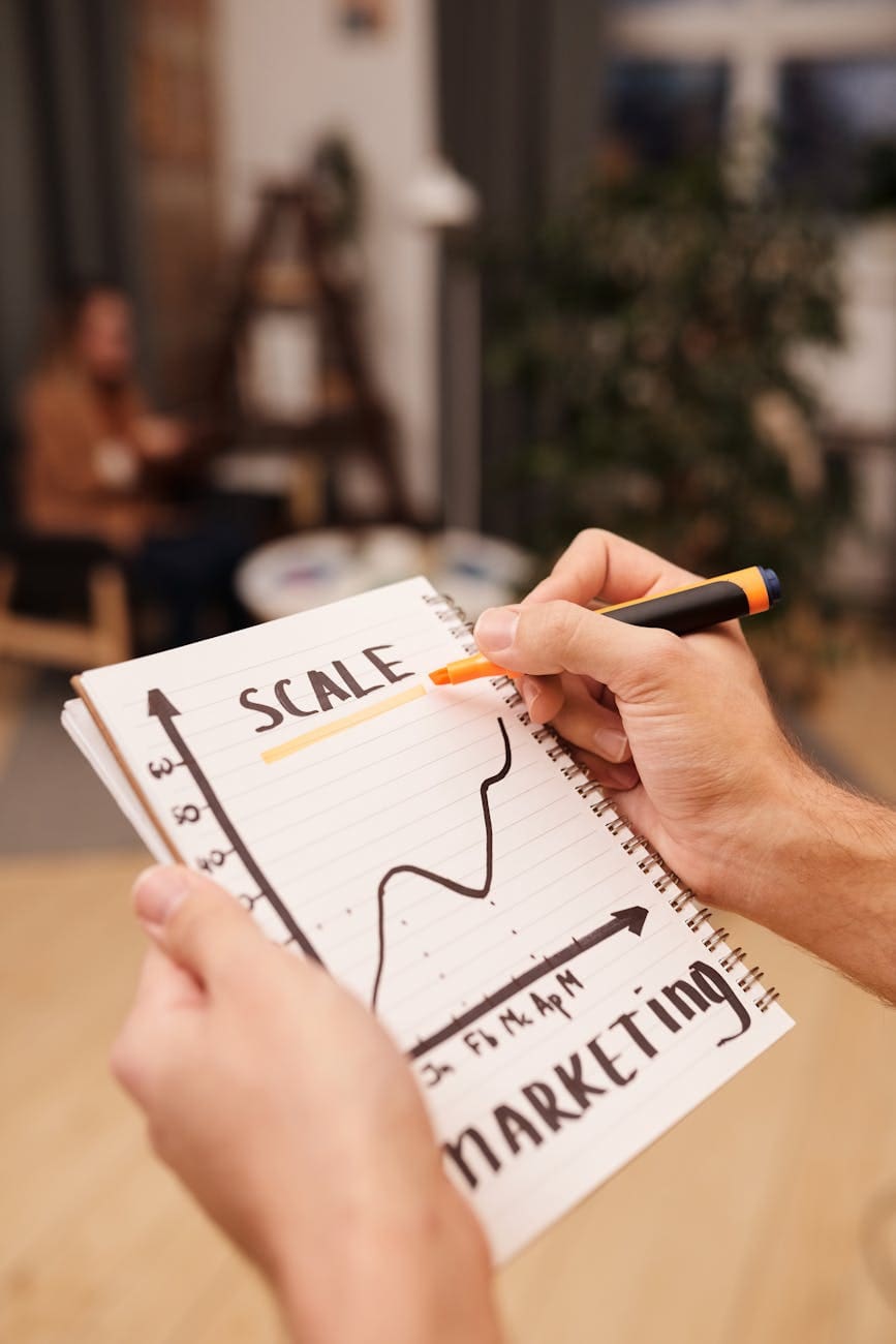 person drawing on a notebook