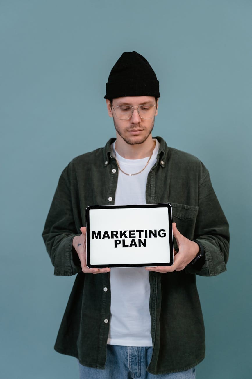man holding a tablet computer showing startup message